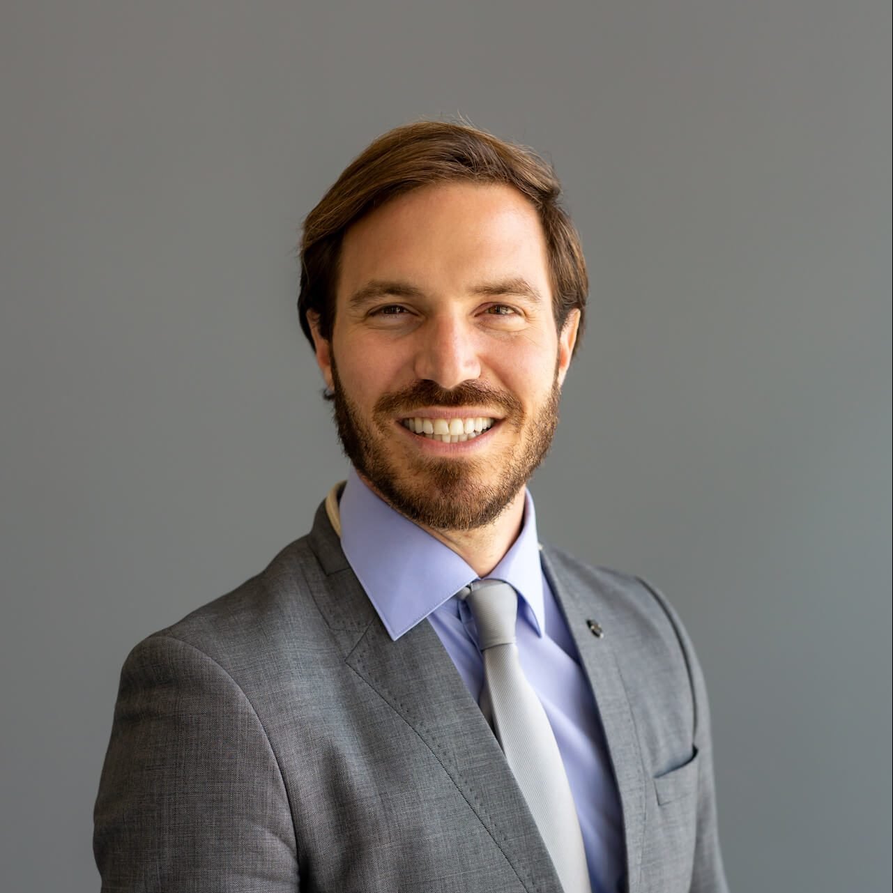 handsome smiling confident businessman portrait in 2021 08 30 07 47 24 utc e1656565431887.jpg