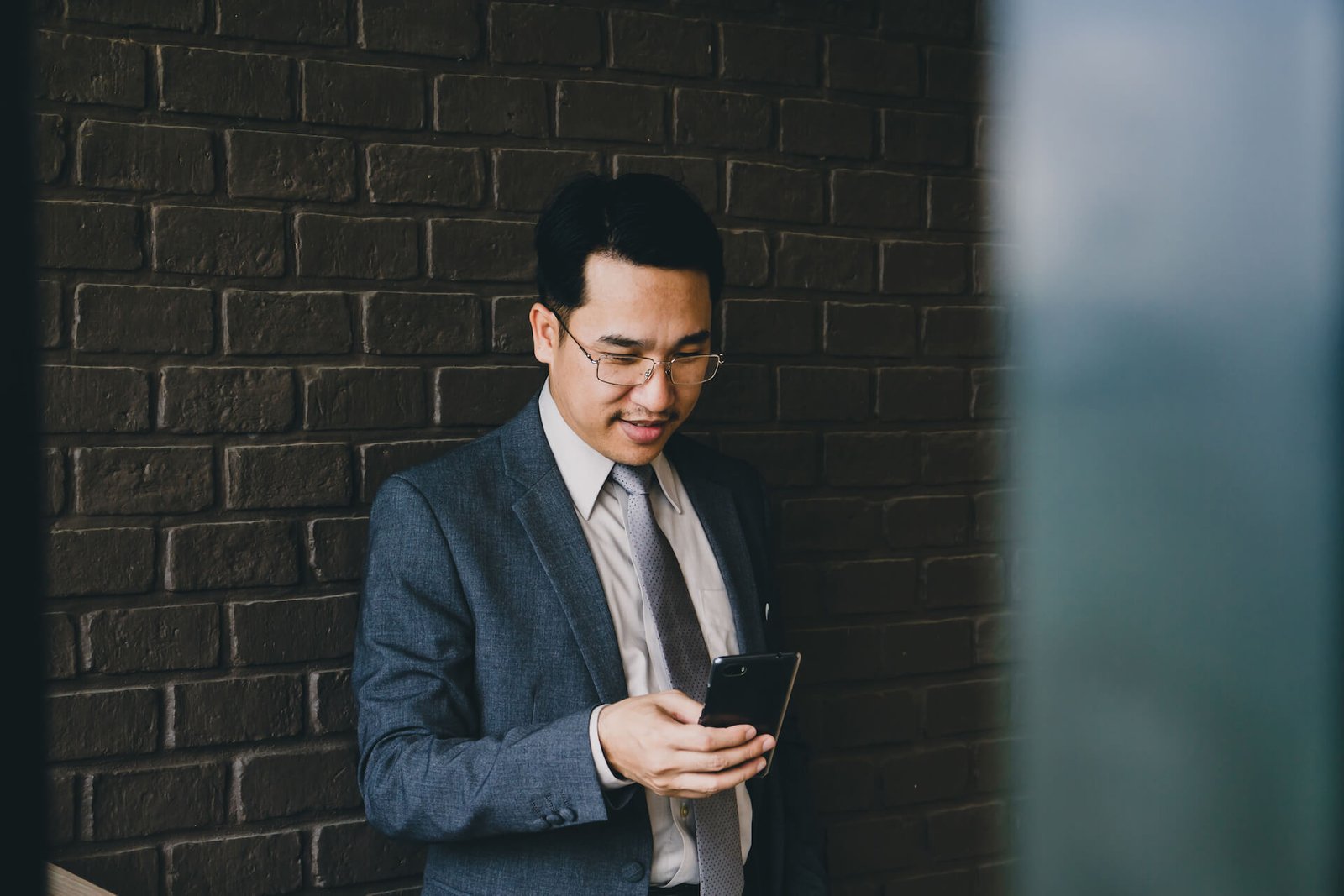 happy asian businessman using smart phone 2021 09 04 09 57 06 utc.jpg