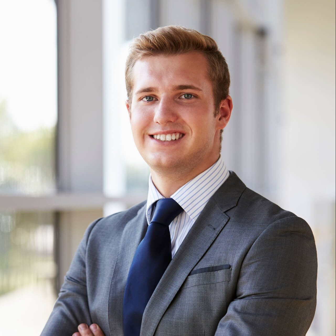 portrait of a young smiling professional man arms 2021 08 26 16 13 59 utc 1 e1656565117637.jpg